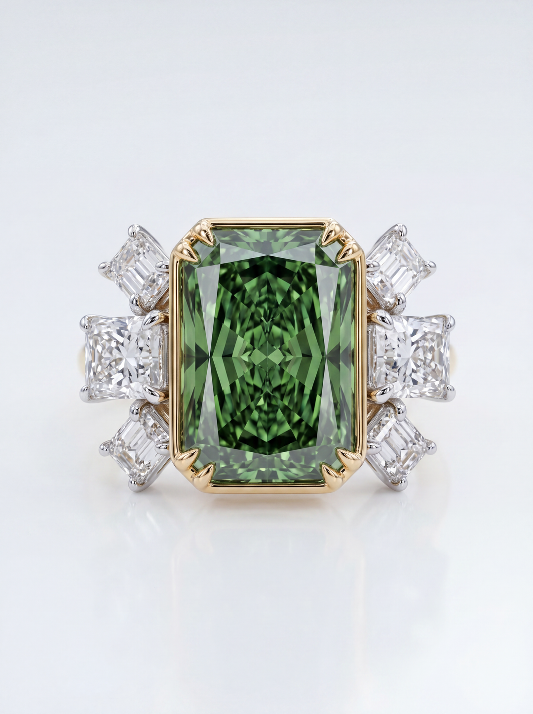 Green gemstone ring with gold and diamond accents on a white background
