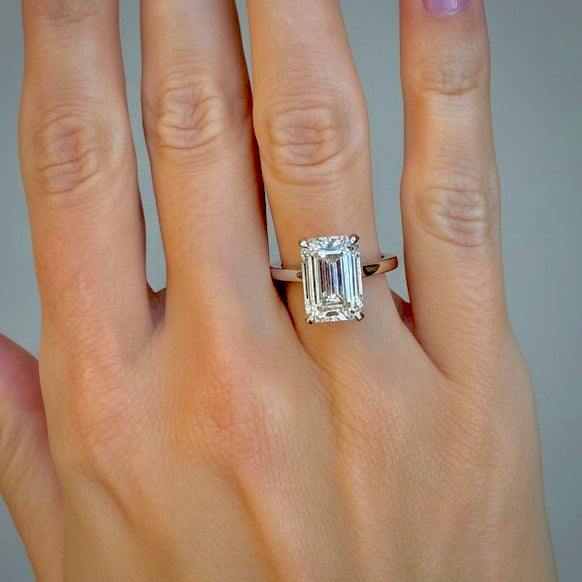5 ct emerald-cut lab-grown diamond hidden halo ring shown on the hand