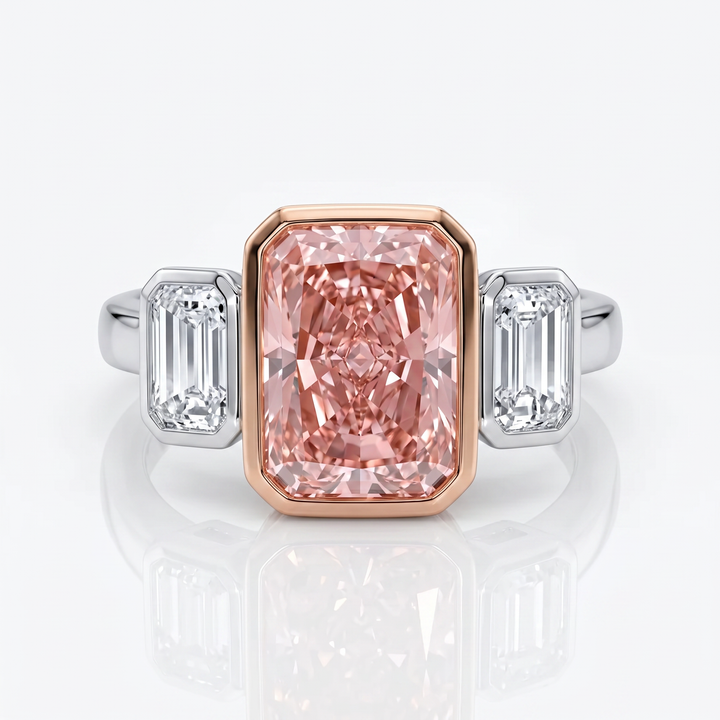 Azuri three-stone ring with radiant-cut Fancy Vivid Pink lab-grown diamond in 18K rose gold bezel and baguette side stones in white gold — studio view