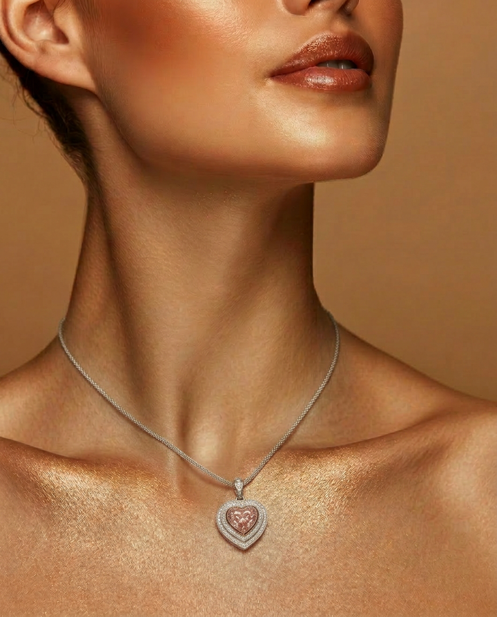Model wearing the Fancy Vivid Pink heart-shape lab-grown diamond pendant on a fine chain
