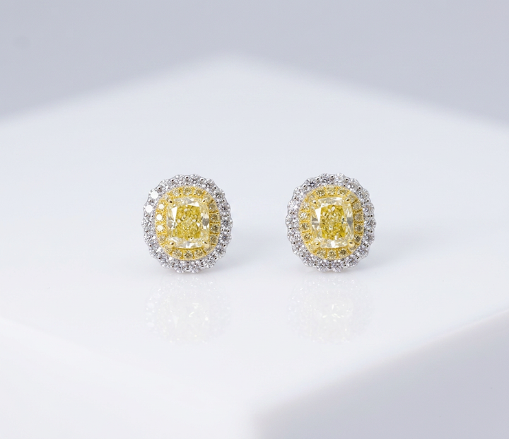 Fancy Vivid Yellow cushion-cut lab-grown diamond stud earrings with double micro-pavé halos in 14K white gold — studio view