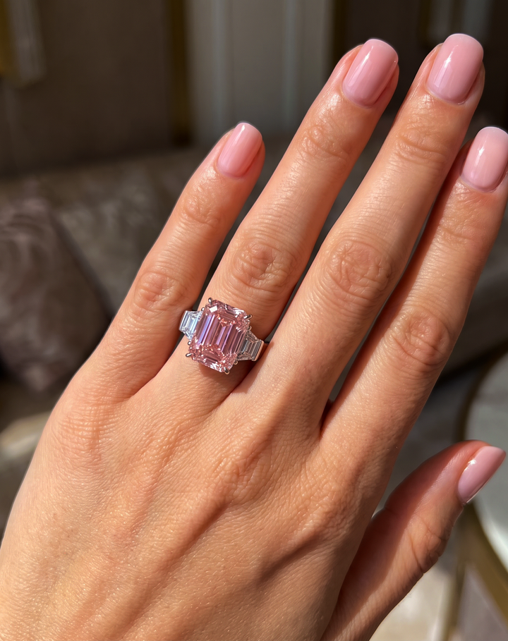 Fancy Vivid Pink emerald-cut lab-grown diamond three-stone ring worn on the hand