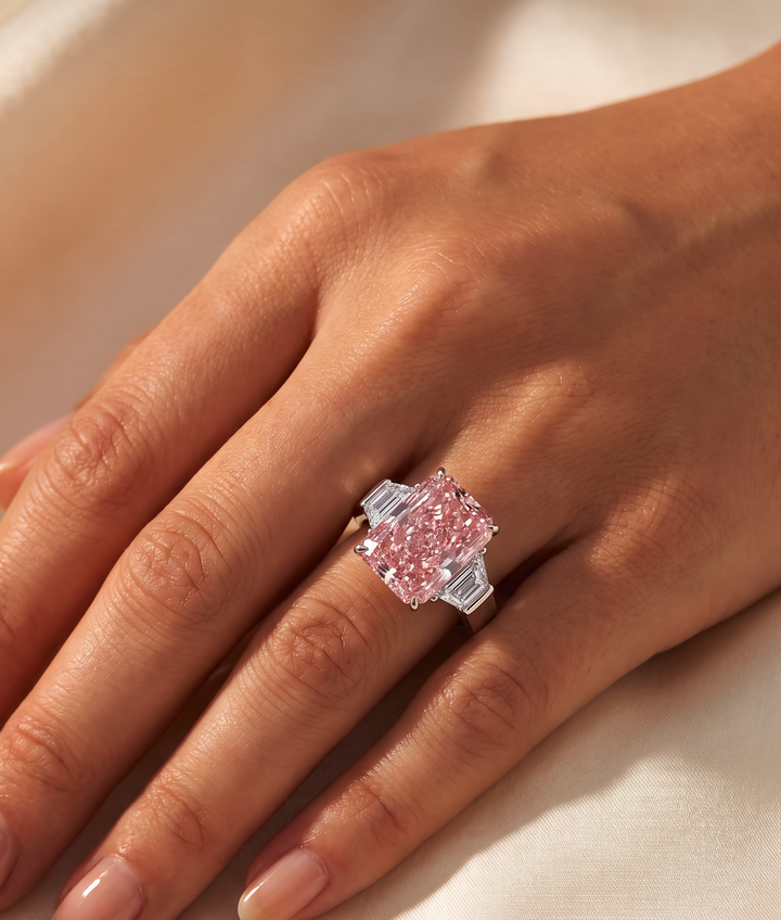 Model wearing the Fancy Vivid Pink radiant-cut lab-grown diamond three-stone ring in rose gold