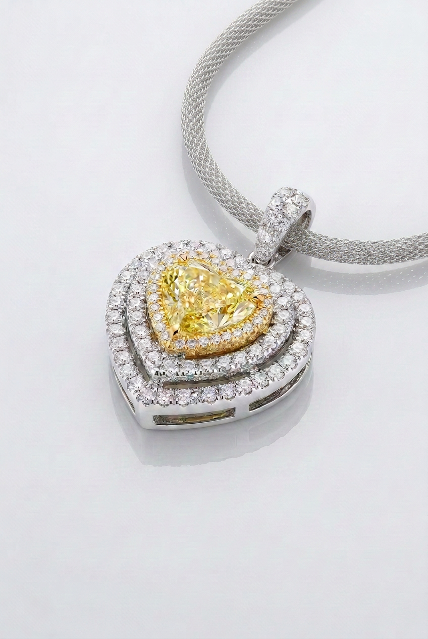 2 ct Fancy Vivid Yellow heart-shape lab-grown diamond pendant with yellow gold frame and double white pavé halo in 14K white gold — studio view
