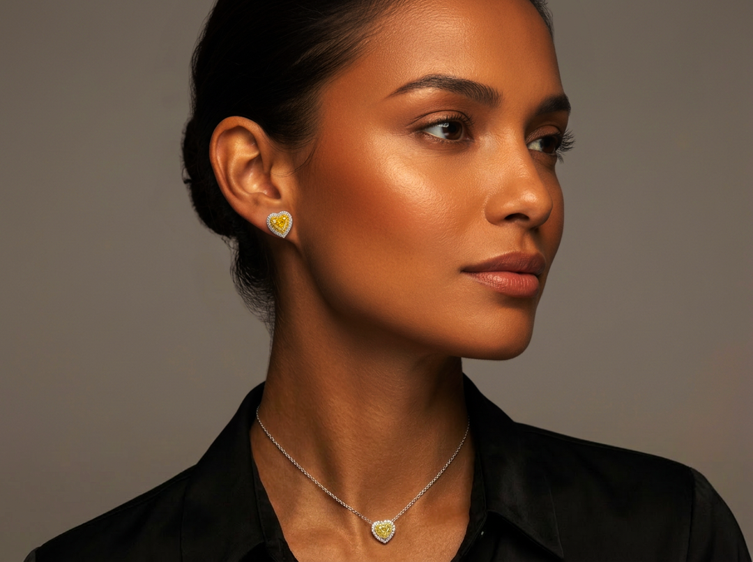 Model wearing the Fancy Vivid Yellow heart lab-grown diamond pendant and matching stud earrings