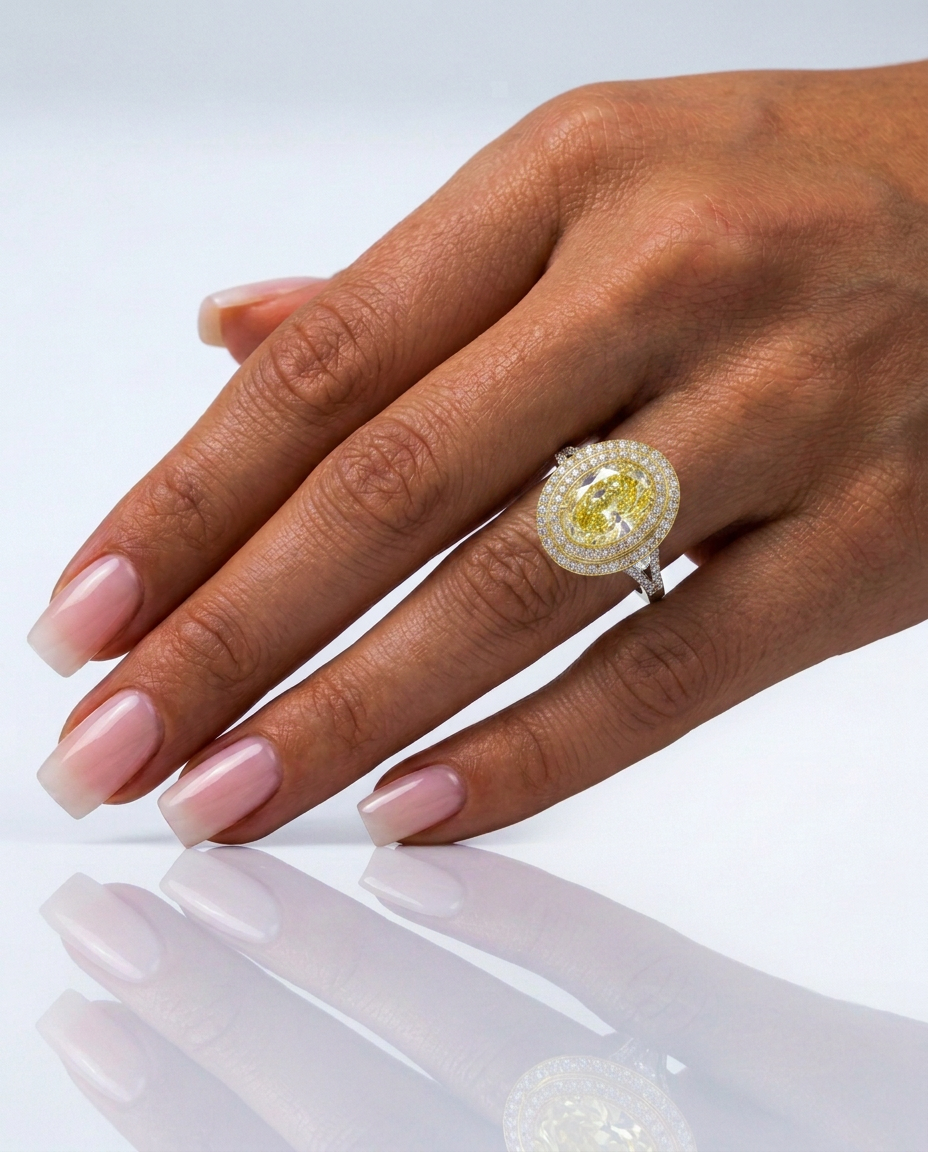 Model wearing the Fancy Vivid Yellow oval lab-grown diamond double halo ring in 14K gold