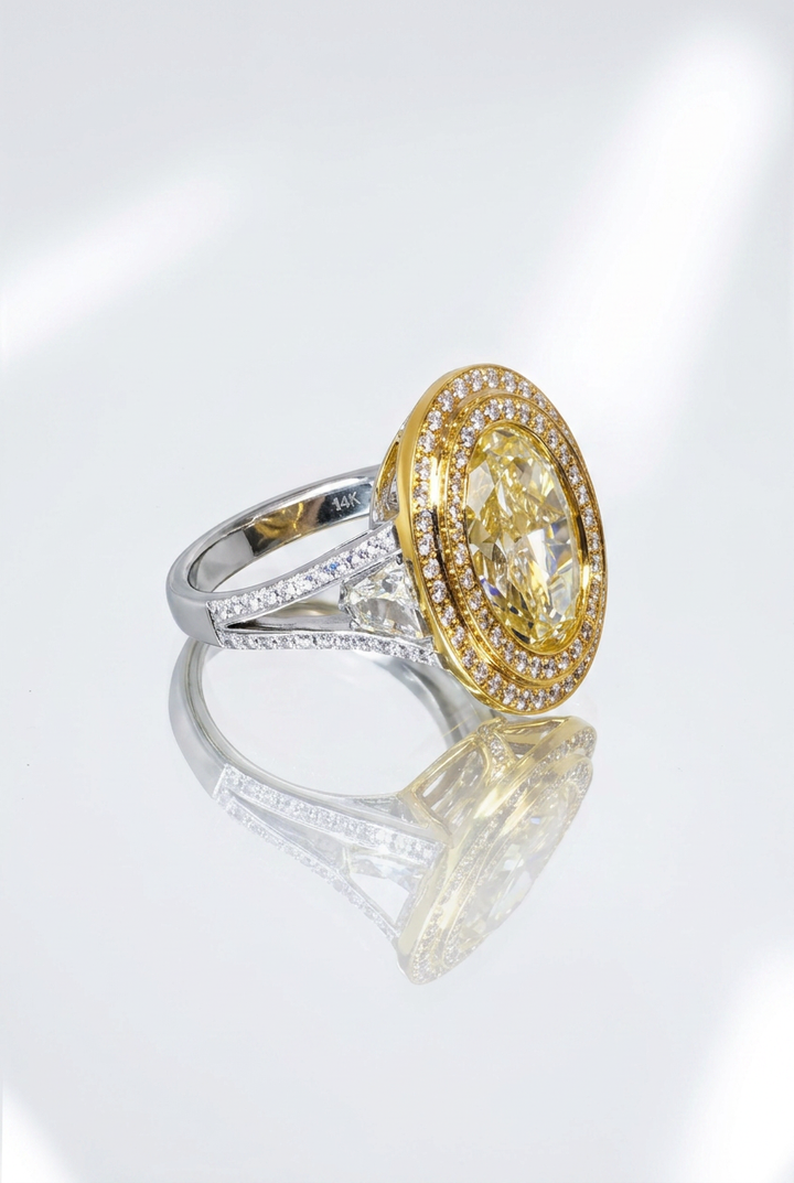 Side view of the Fancy Vivid Yellow oval lab-grown diamond double halo ring showing the shield-cut side stone in the split shoulder