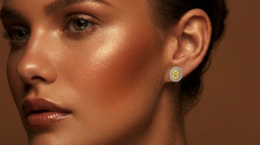 Model wearing the Fancy Vivid Yellow oval lab-grown diamond double halo stud earring