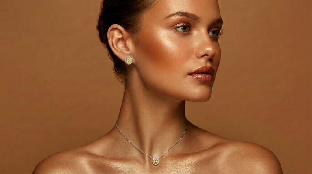 Model wearing the Fancy Vivid Yellow oval lab-grown diamond stud earrings with the matching pendant