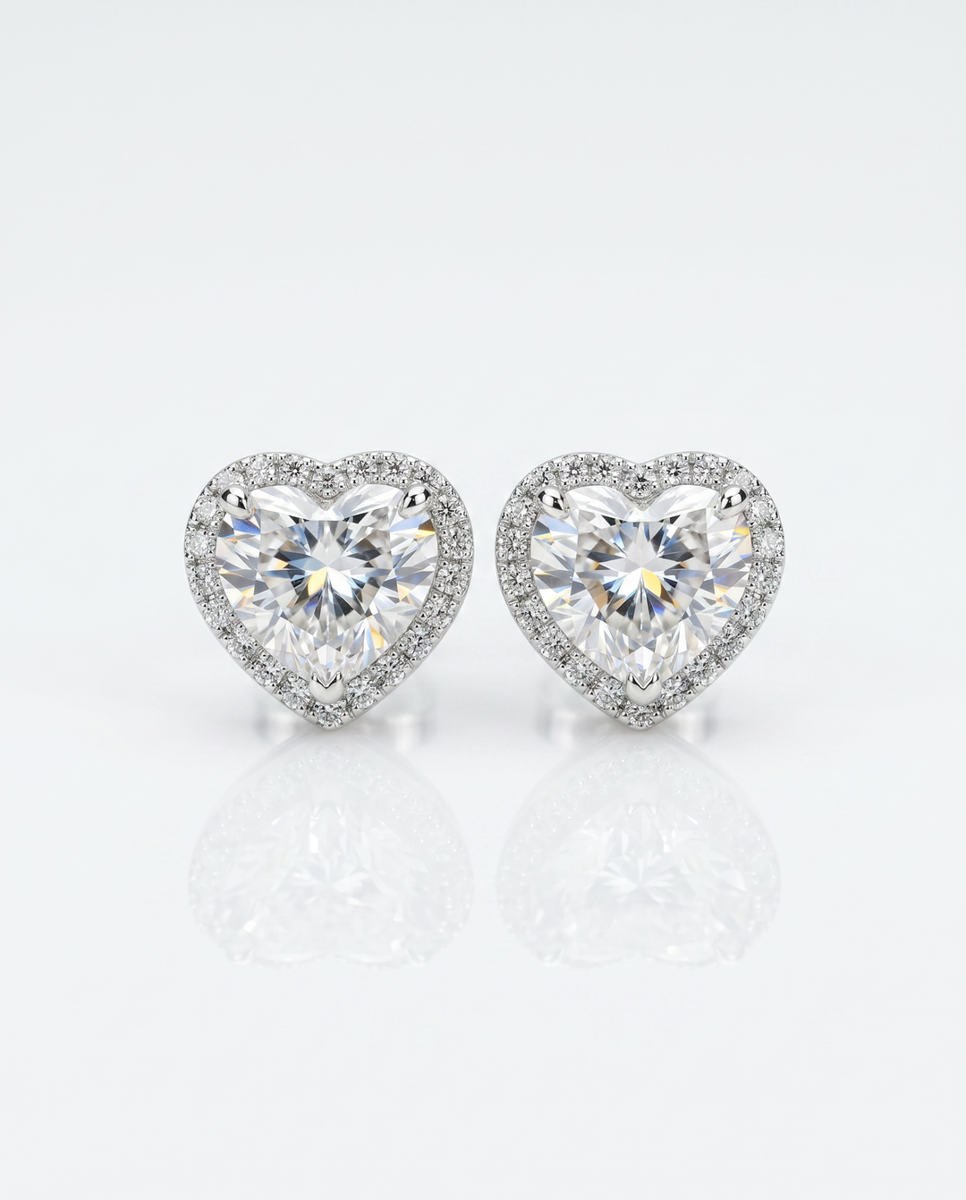 Heart-shape lab-grown diamond halo stud earrings with micro-pavé halos in 14K white gold — studio view