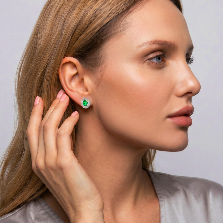 Model wearing the oval lab-grown emerald double halo stud earring in 14K white gold