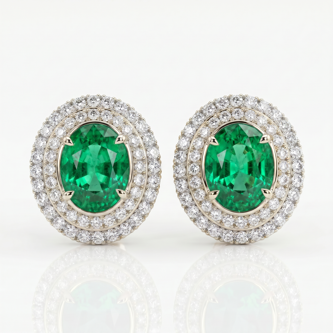 Oval lab-grown emerald stud earrings with invisible-set double diamond pavé halos in 14K white gold — studio view