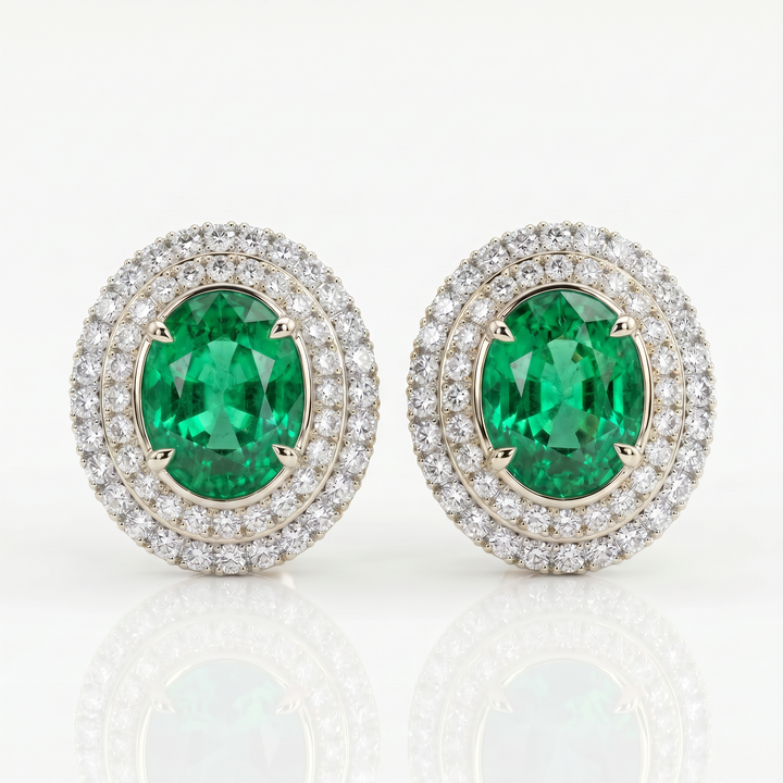 Oval lab-grown emerald stud earrings with invisible-set double diamond pavé halos in 14K white gold — studio view
