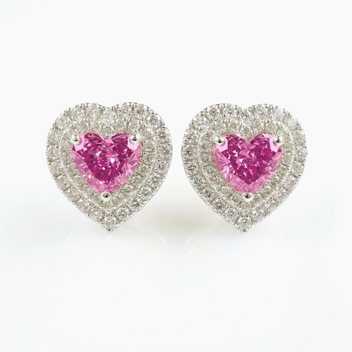 Heart-shaped pink lab-grown sapphire stud earrings with double pavé diamond halos in 14K white gold, 1 ct each