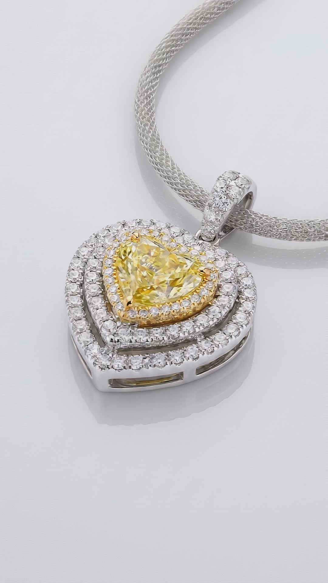 Video of the 2 ct Fancy Vivid Yellow heart-shape lab-grown diamond double halo pendant