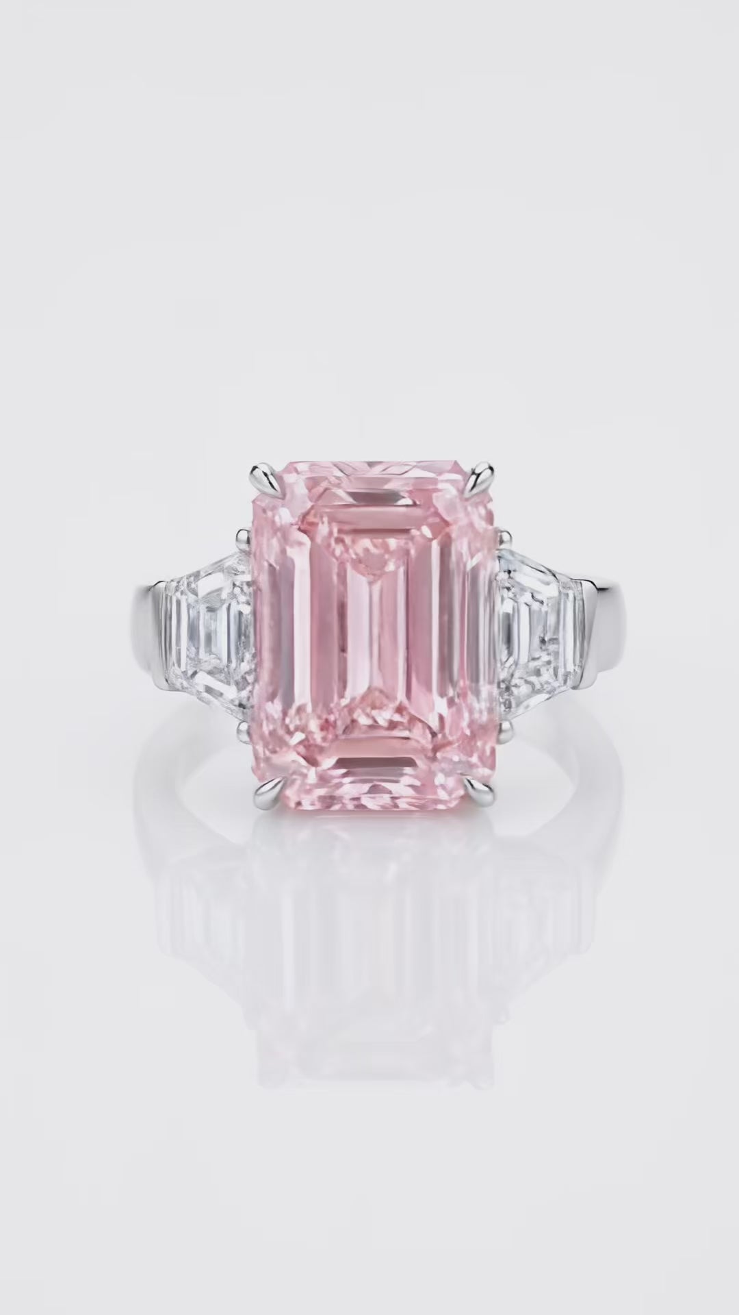Video of the 7.5 ct Fancy Vivid Pink emerald-cut lab-grown diamond three-stone ring