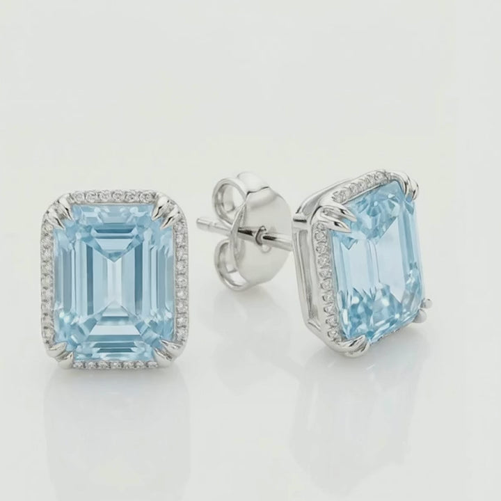 Rotation video of the fancy blue emerald-cut diamond halo stud earrings